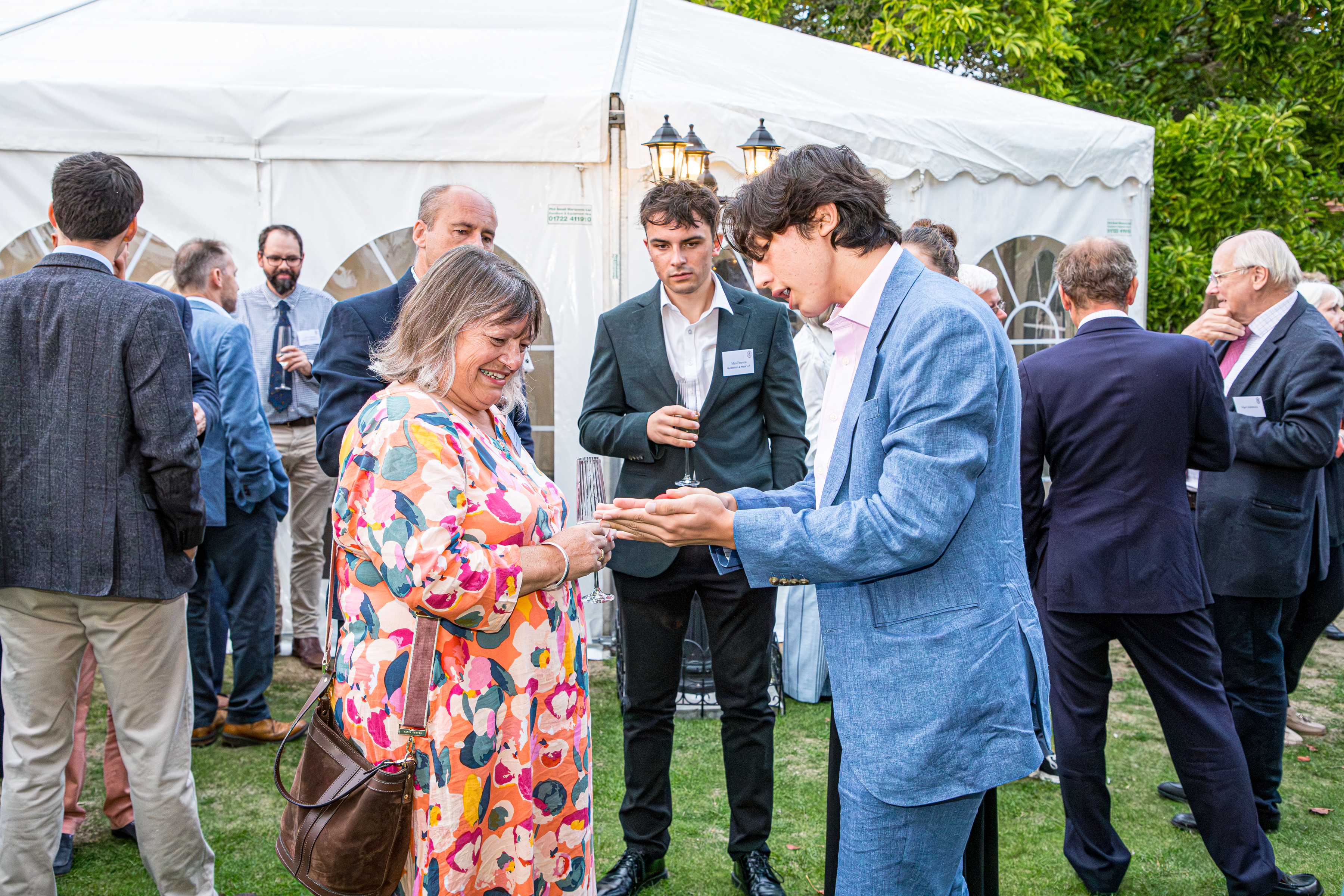 Noah performing close-up magic at the Wilsons summer party