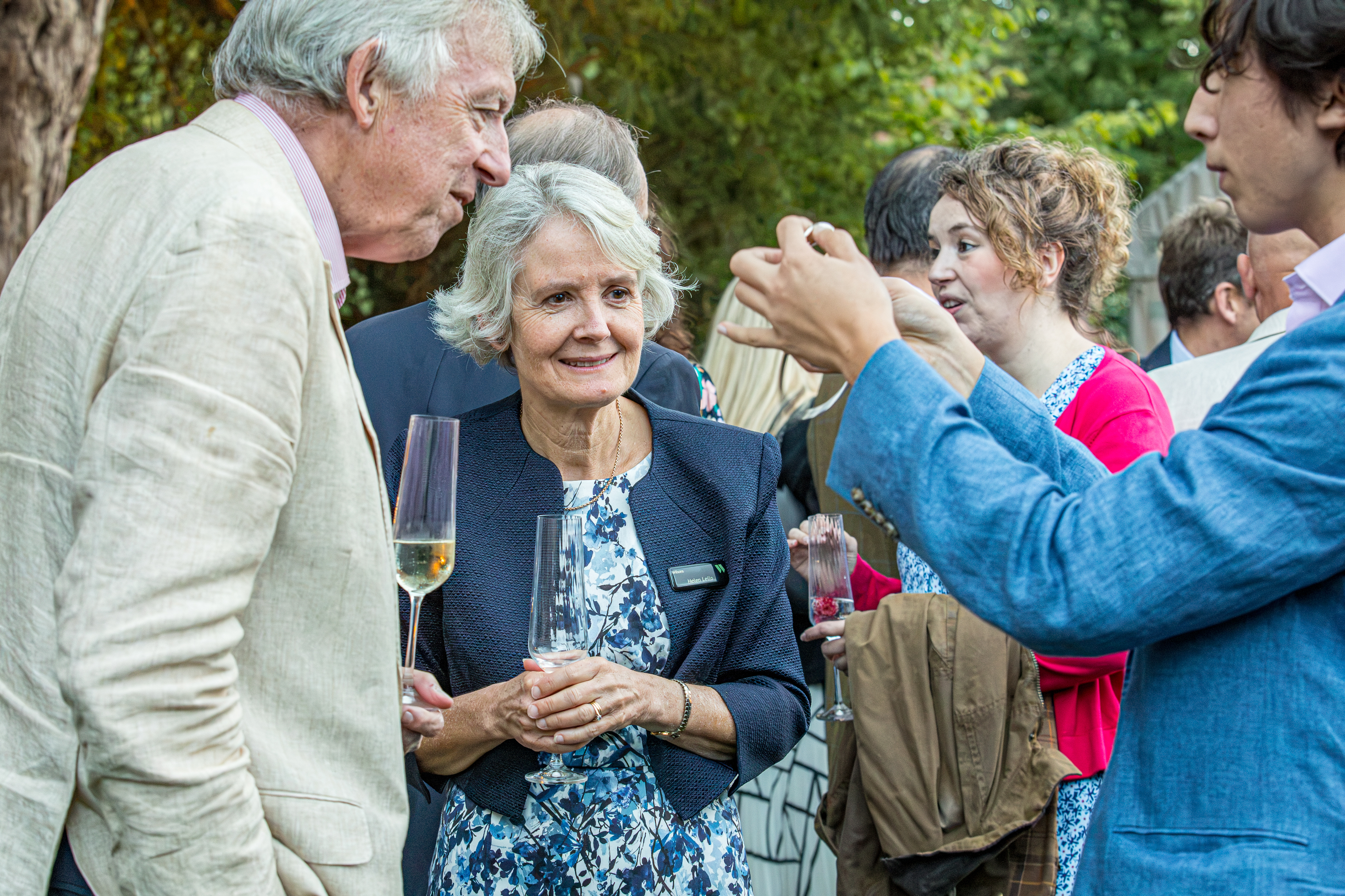 Close-up magic among guests at the Wilsons summer party